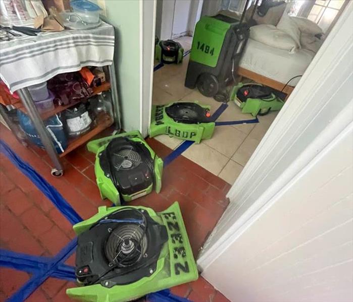 Green drying equipment in a bedroom.