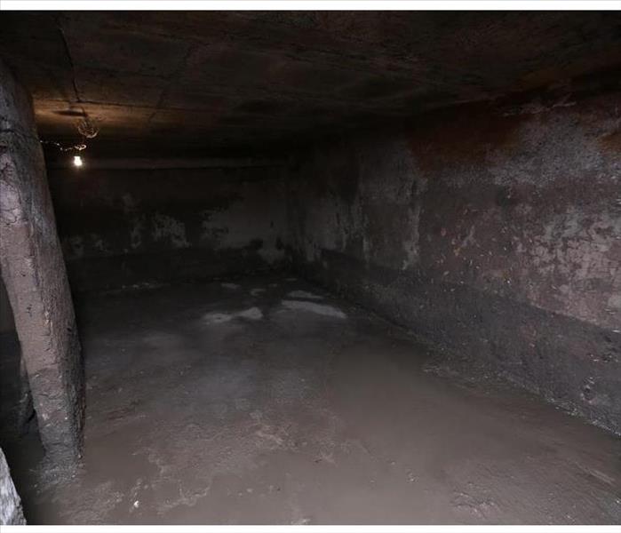 Old dirty cellar flooded from a pipe break,